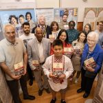 Mayor of the Causeway Coast and Glens, Councillor Steven Callaghan with A World of Stories participants and Museum Services staff at the exhibition in Coleraine Town Hall.